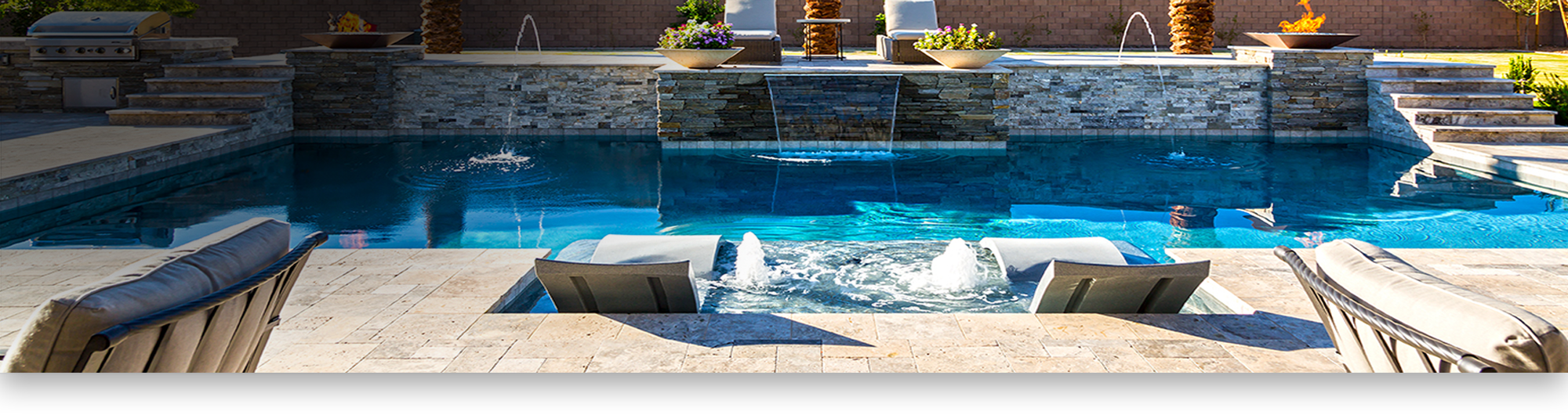 Travertine poolside with deckchairs and bar-b-q
